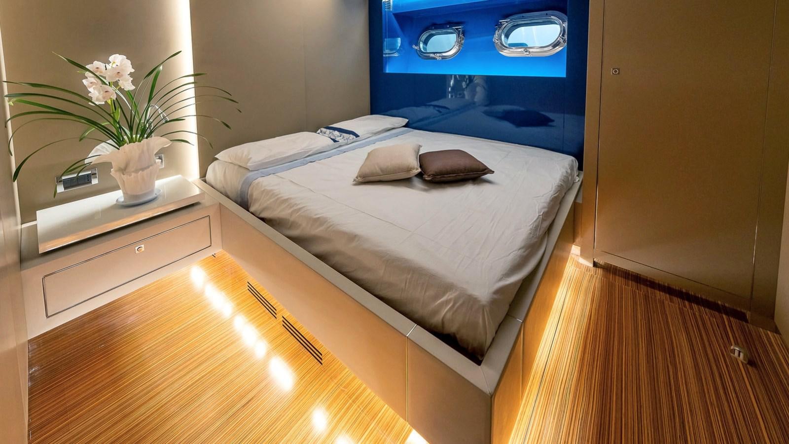a bed with a white bed aboard MAXI DRAGO Yacht for Sale