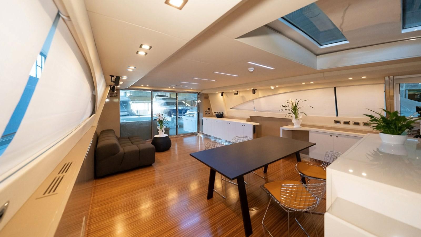 a room with a table and chairs aboard MAXI DRAGO Yacht for Sale