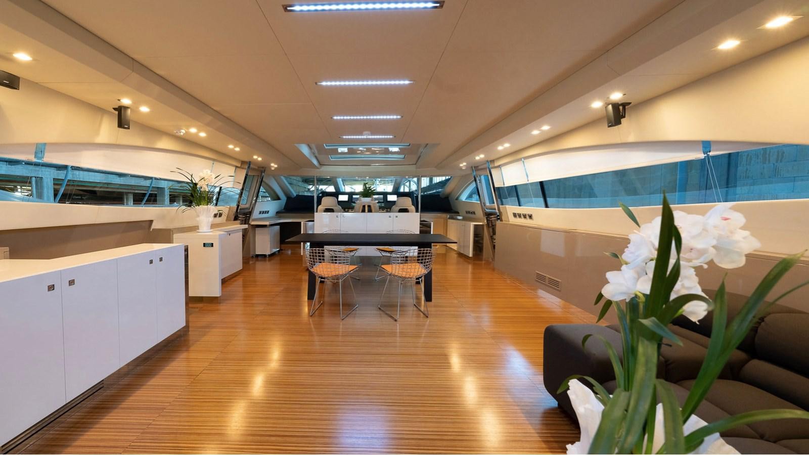 a room with tables and chairs aboard MAXI DRAGO Yacht for Sale