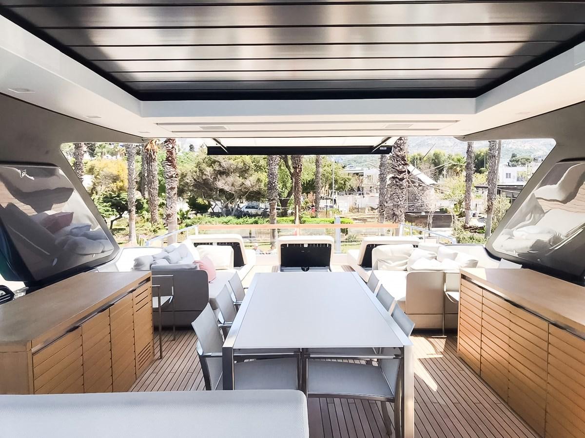 a deck with tables and chairs aboard SANLORENZO SX88/01 Yacht for Sale