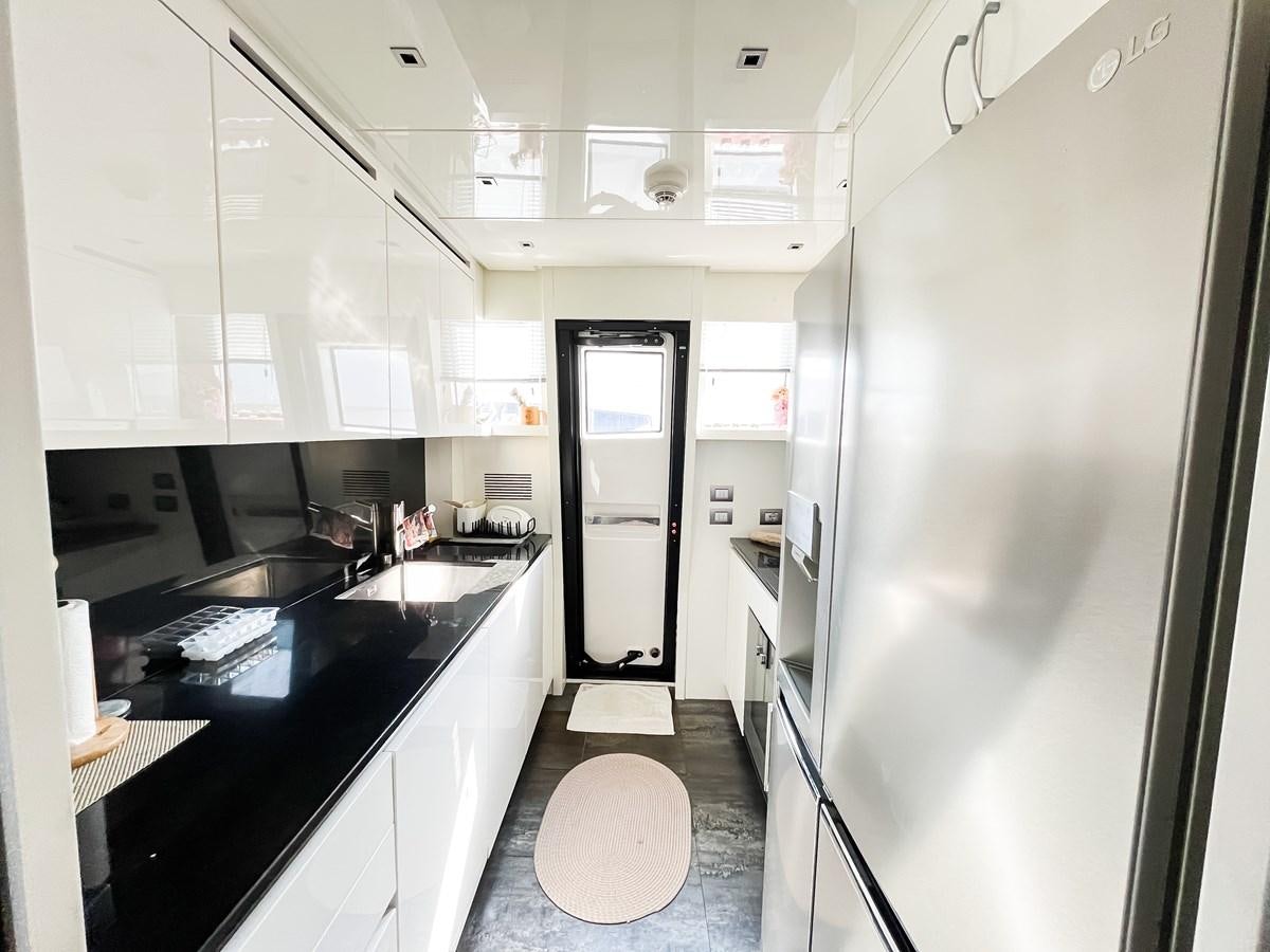 a kitchen with white cabinets aboard SANLORENZO SX88/01 Yacht for Sale
