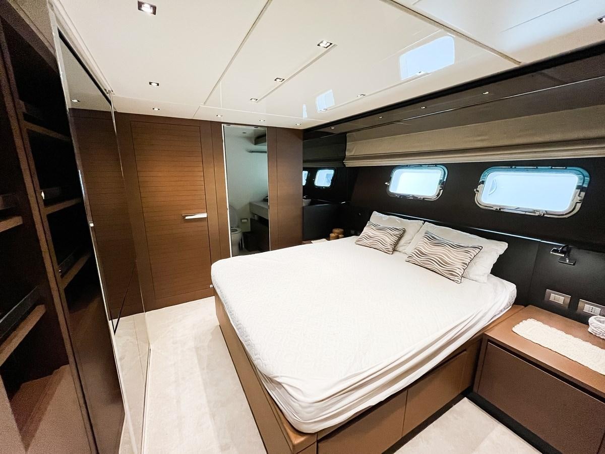 a room with a bed and a window aboard SANLORENZO SX88/01 Yacht for Sale