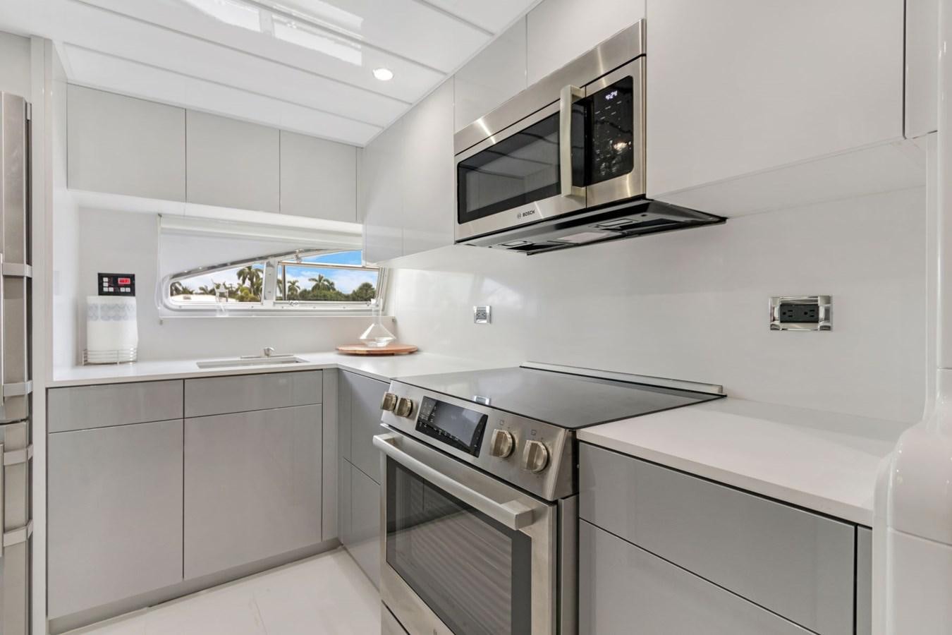 a kitchen with white cabinets aboard SINPATICO Yacht for Sale