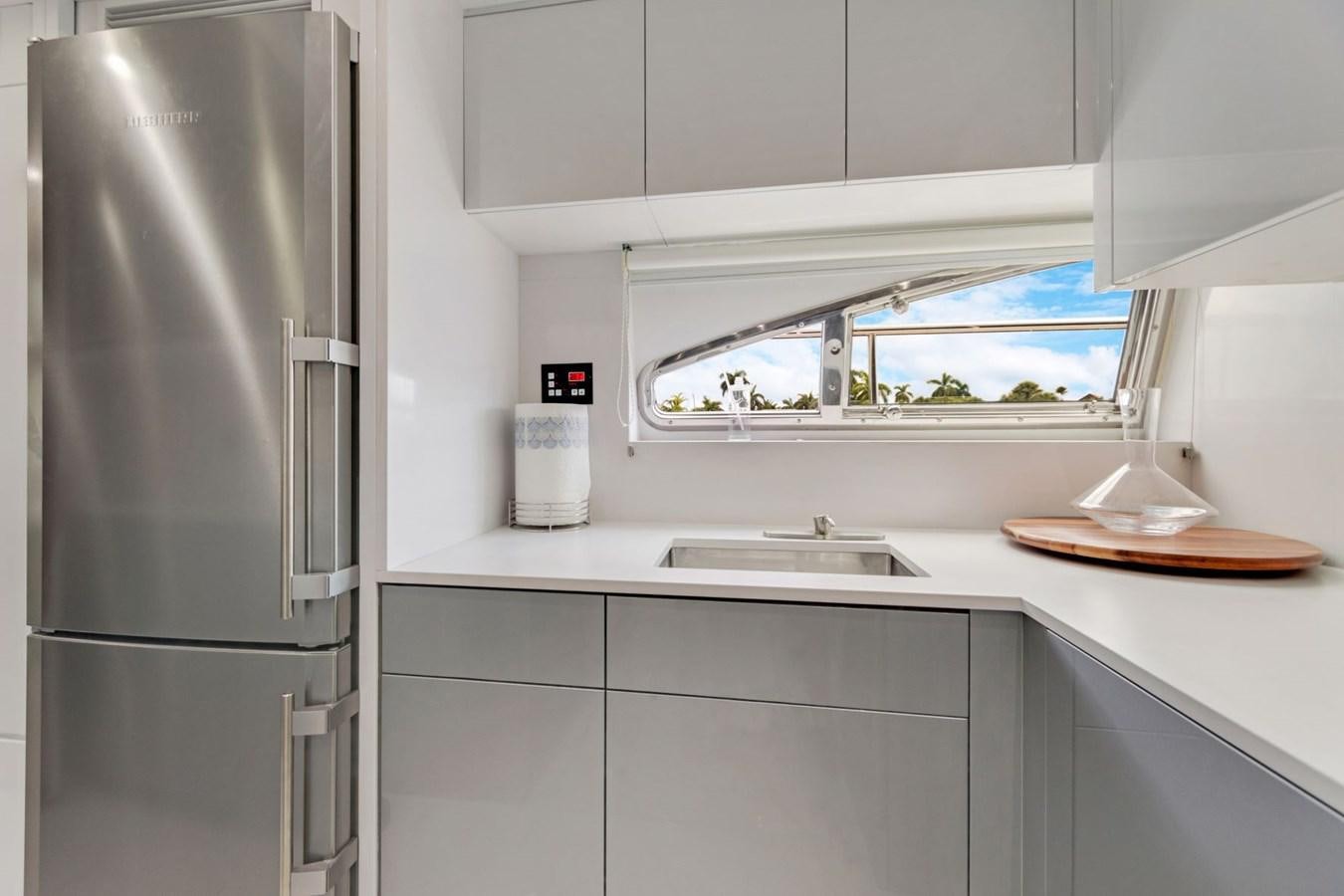 a kitchen with a refrigerator and sink aboard SINPATICO Yacht for Sale