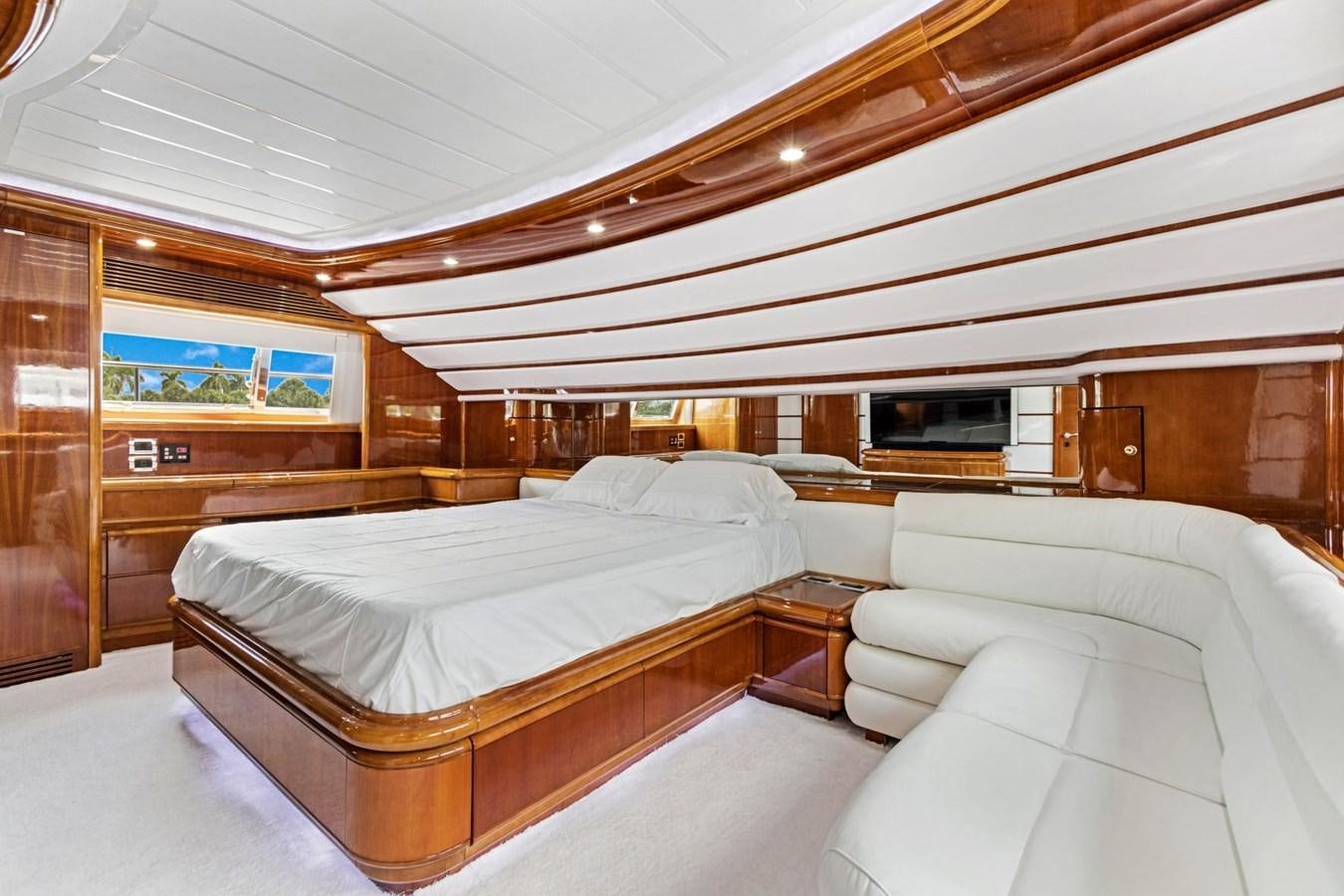a room with a bed and a television aboard SINPATICO Yacht for Sale