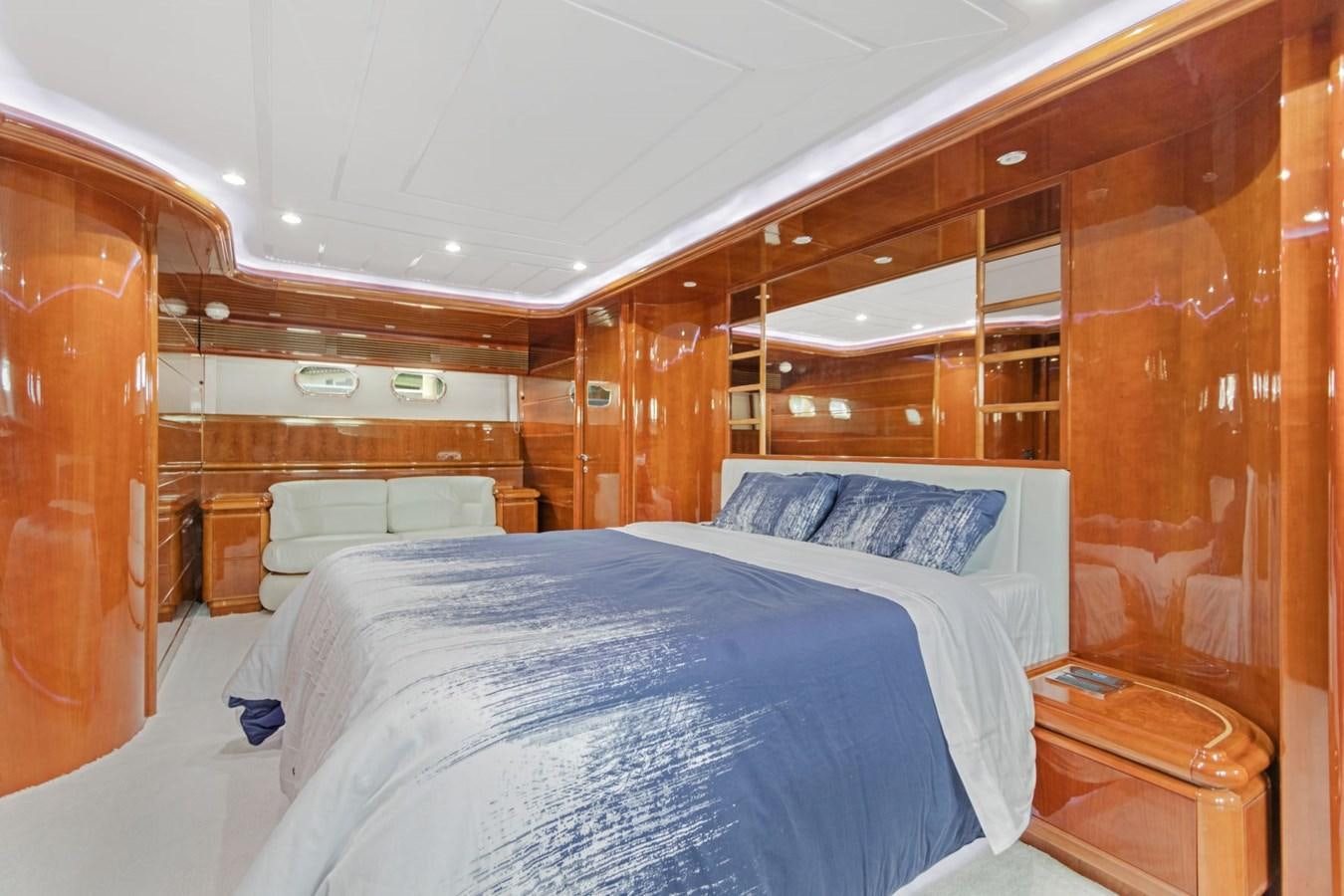 a room with a bed and a wood wall aboard SINPATICO Yacht for Sale