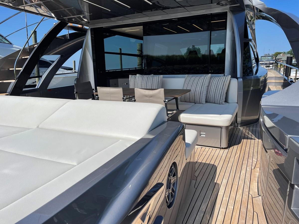 a large white bed with a white couch and a large window aboard NICKY D Yacht for Sale