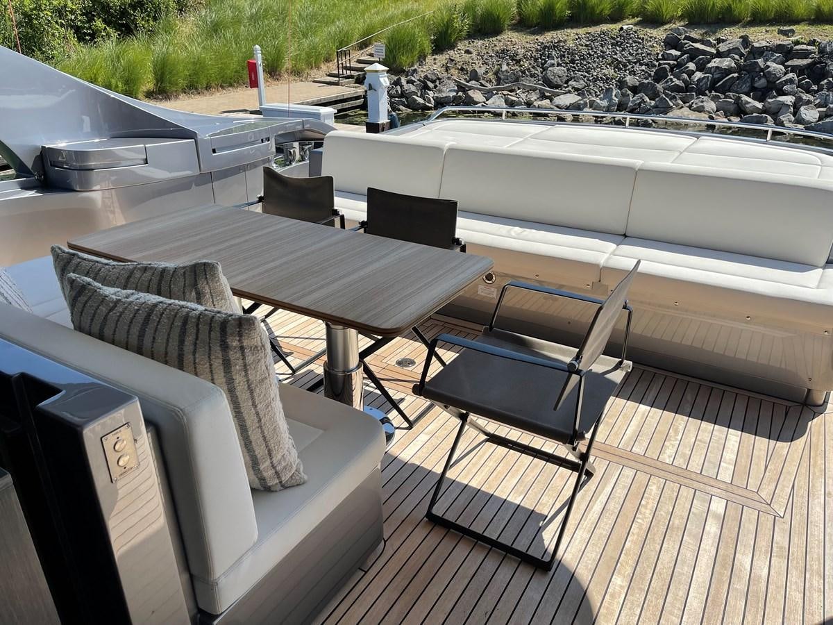 a table and chairs on a deck aboard NICKY D Yacht for Sale