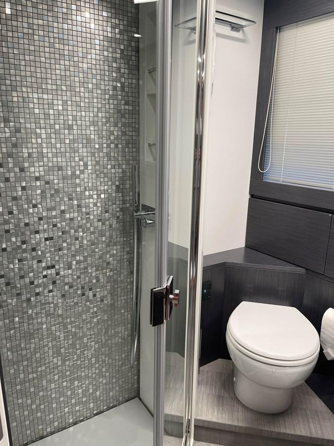 a bathroom with a glass shower aboard NICKY D Yacht for Sale