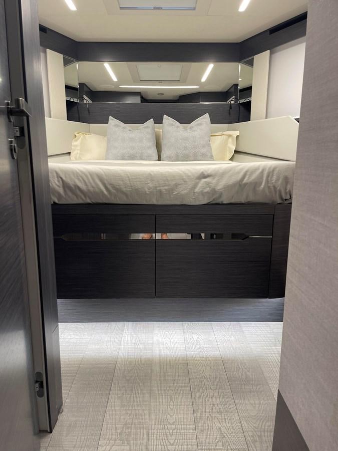 a room with a bed and a mirror aboard NICKY D Yacht for Sale