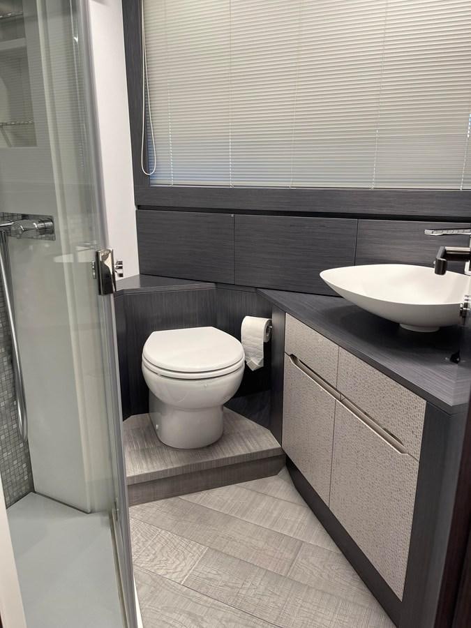 a bathroom with a sink toilet and a mirror aboard NICKY D Yacht for Sale