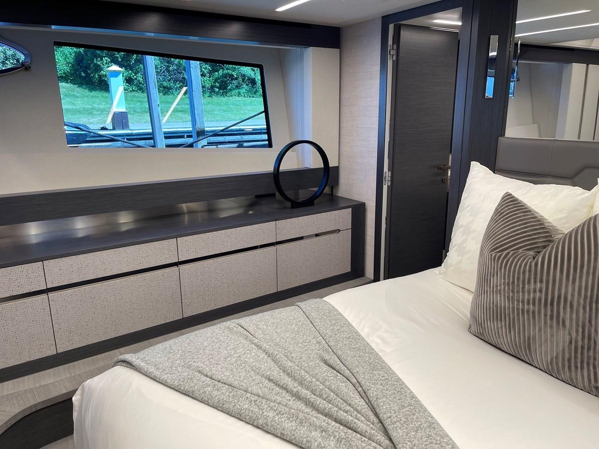 a bed with a white bed spread aboard NICKY D Yacht for Sale