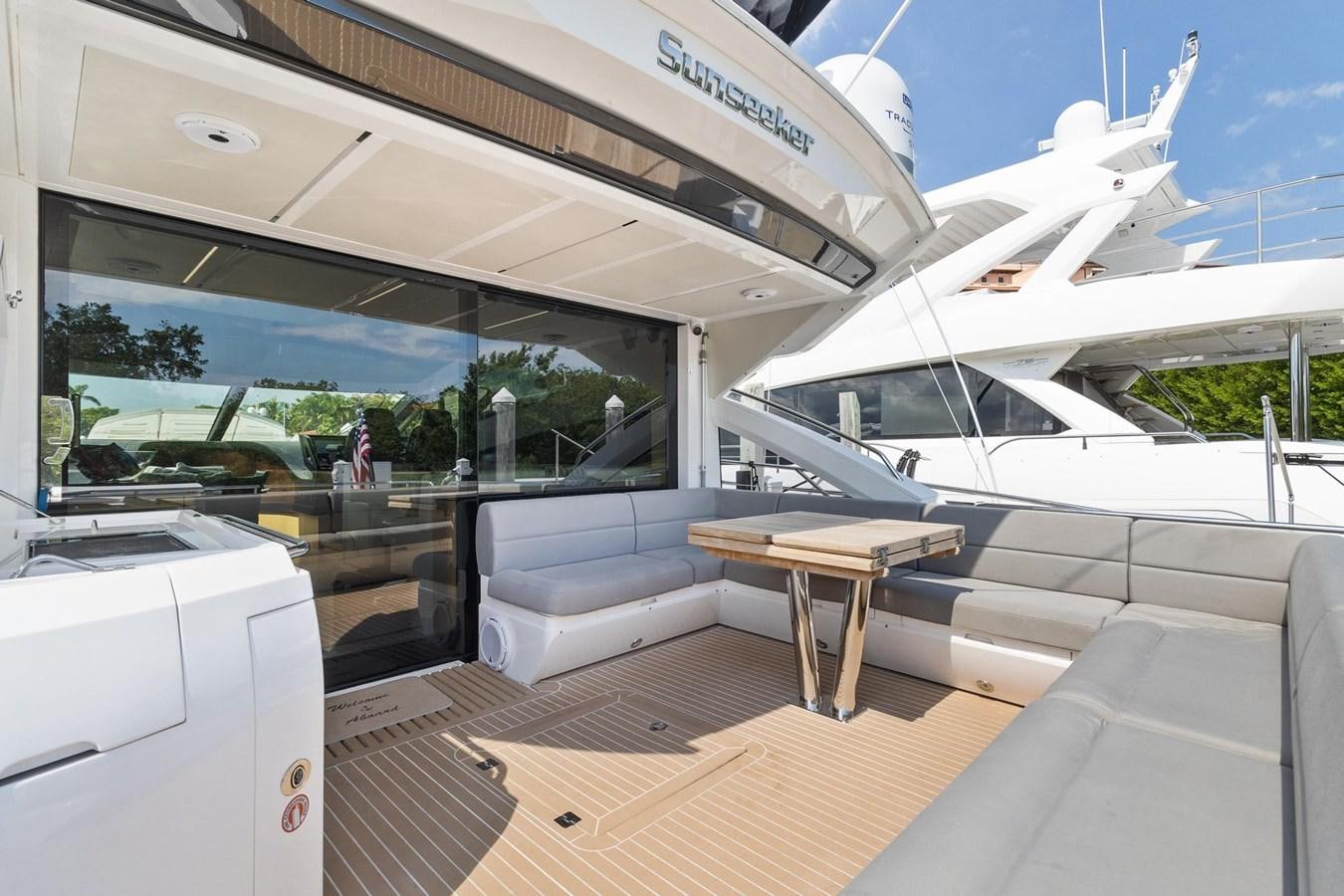 a room with a table and a bench and a boat aboard JOLLY ROGERS Yacht for Sale