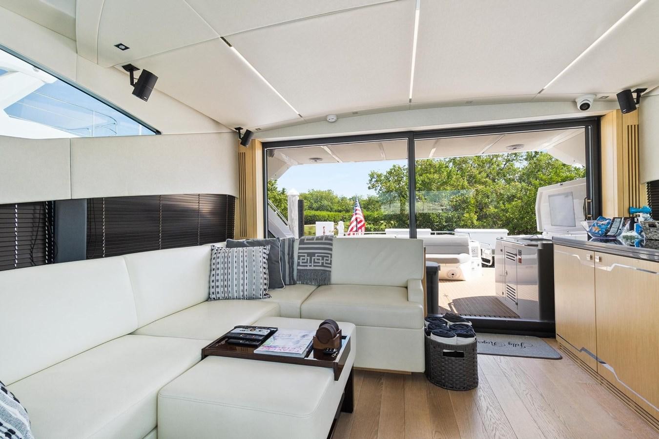 a living room with a couch and a table aboard JOLLY ROGERS Yacht for Sale
