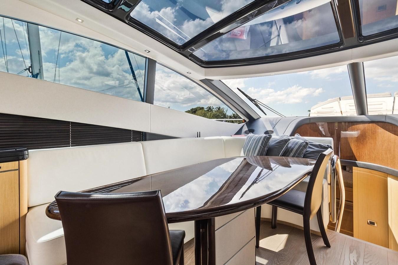 a room with a table and chairs aboard JOLLY ROGERS Yacht for Sale