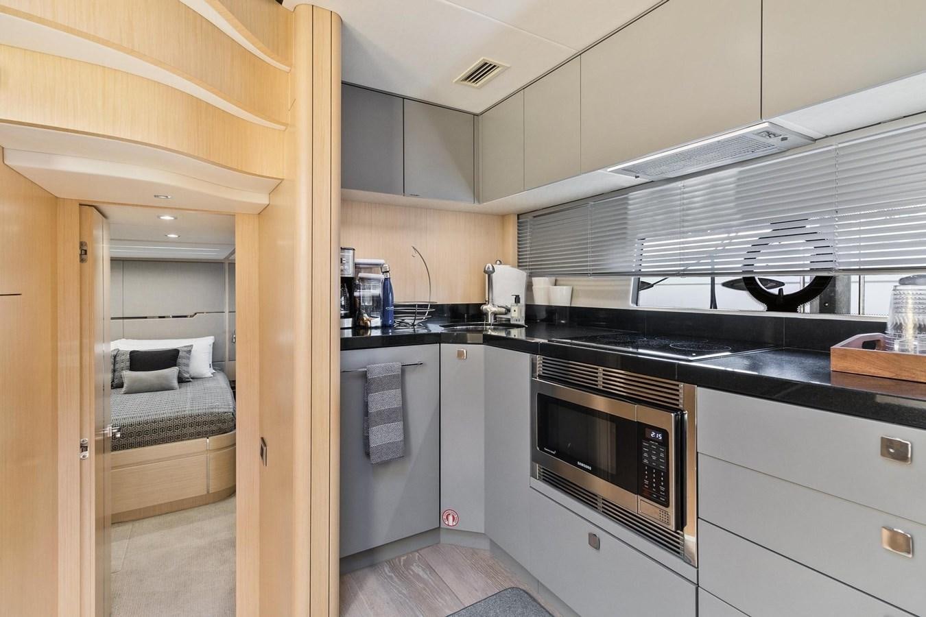 a small kitchen with a bed aboard JOLLY ROGERS Yacht for Sale