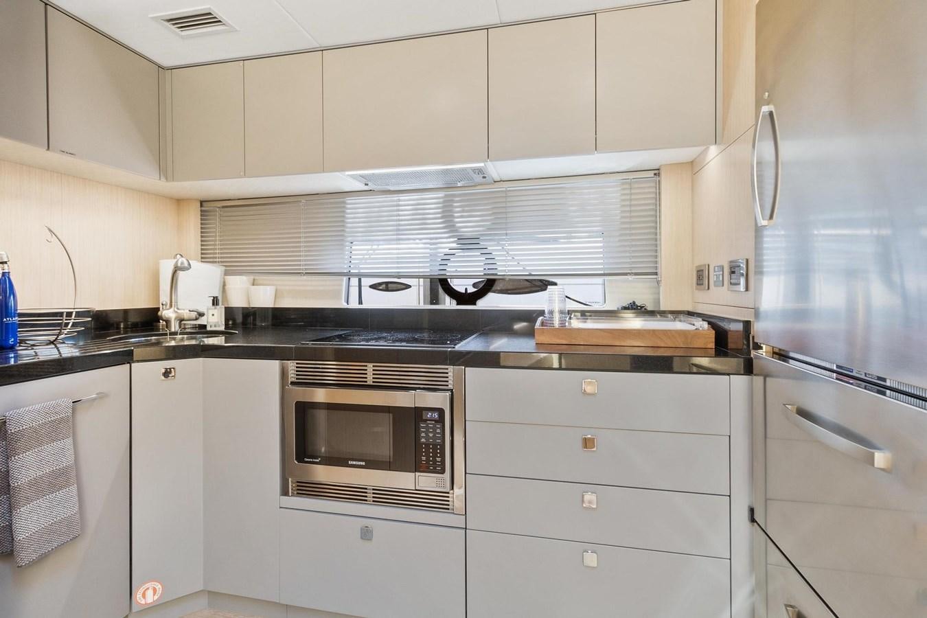 a kitchen with white cabinets aboard JOLLY ROGERS Yacht for Sale