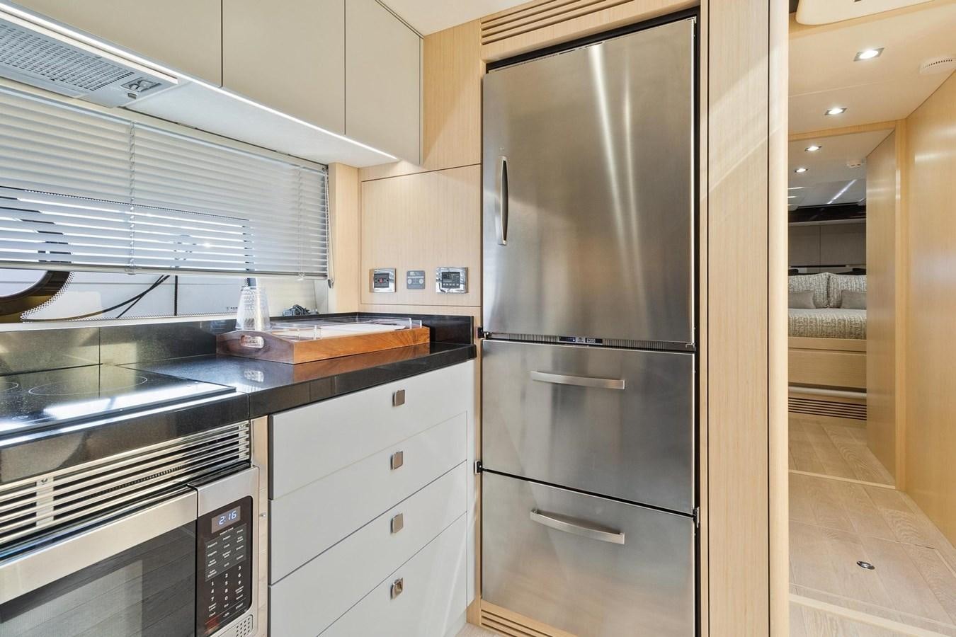 a kitchen with stainless steel appliances aboard JOLLY ROGERS Yacht for Sale