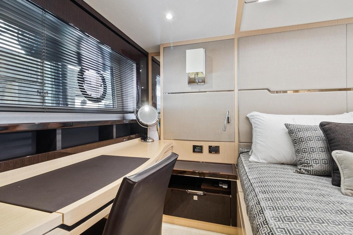 a room with a bed and a desk aboard JOLLY ROGERS Yacht for Sale