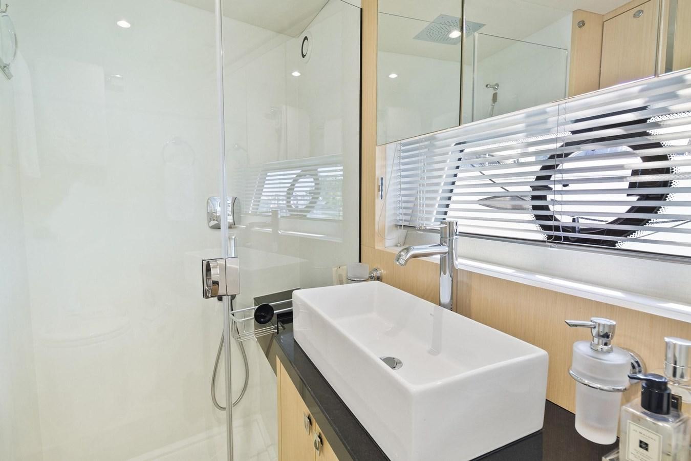 a bathroom with a sink and a mirror aboard JOLLY ROGERS Yacht for Sale