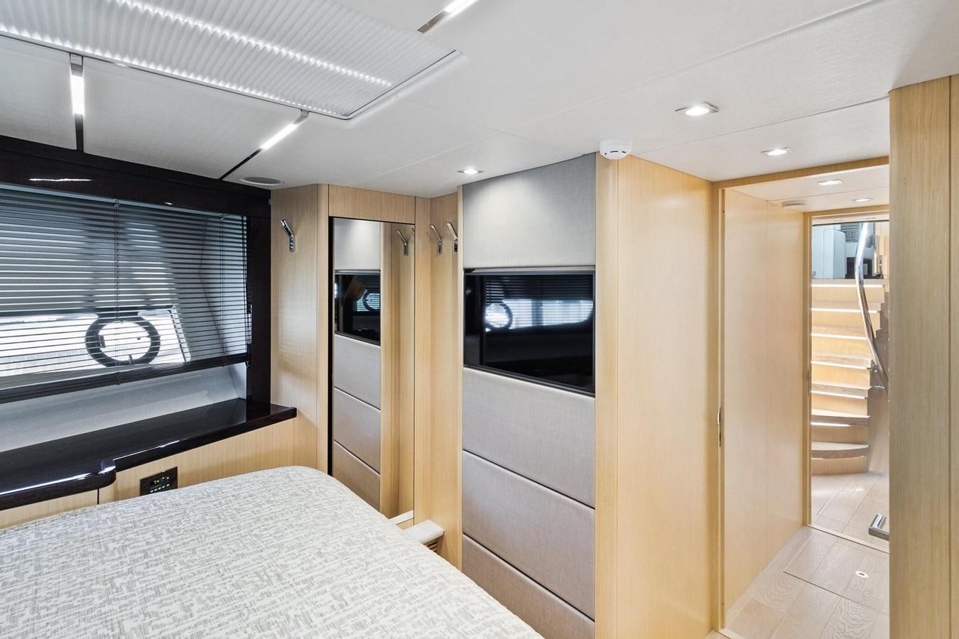 a bedroom with a bed and a television aboard JOLLY ROGERS Yacht for Sale