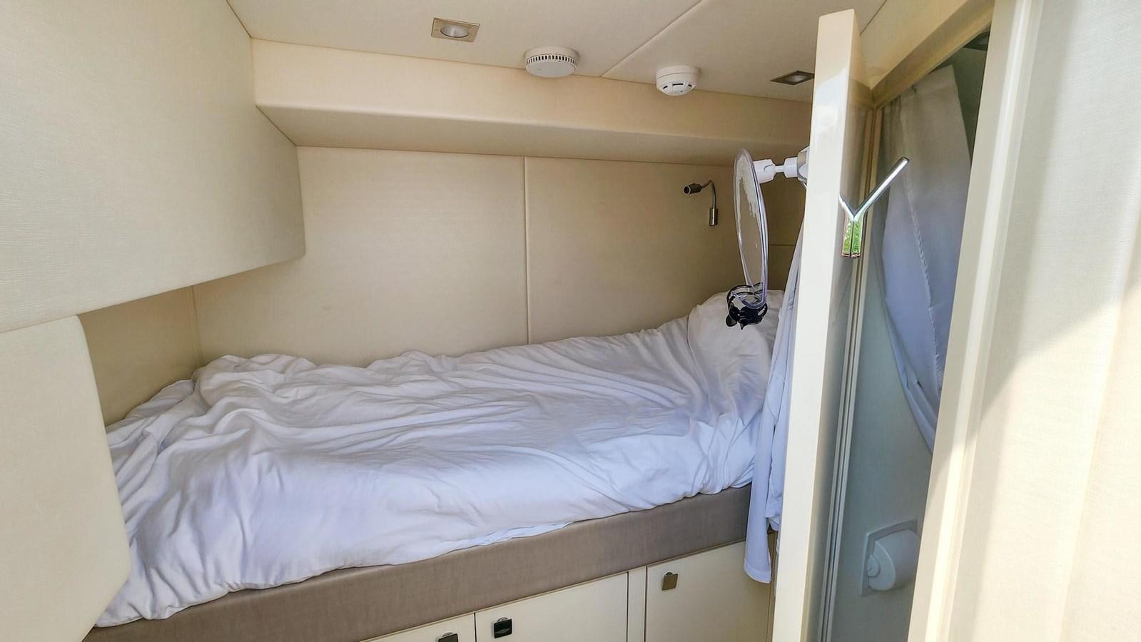 a bed with a white sheet aboard JOLLY ROGERS Yacht for Sale