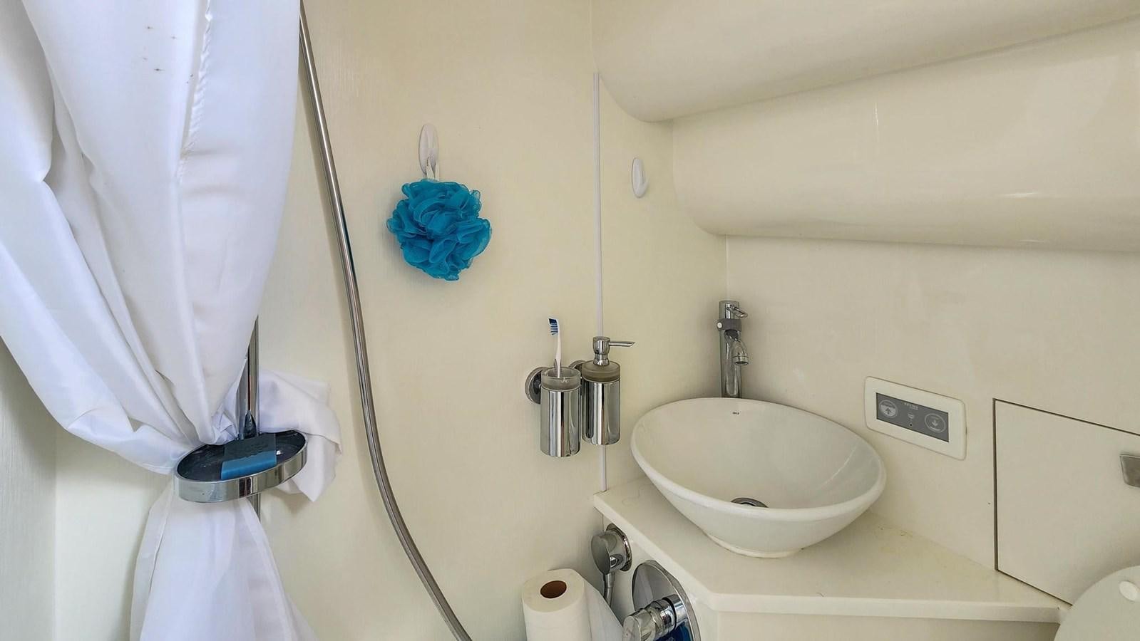 a bathroom with a sink and toilet aboard JOLLY ROGERS Yacht for Sale
