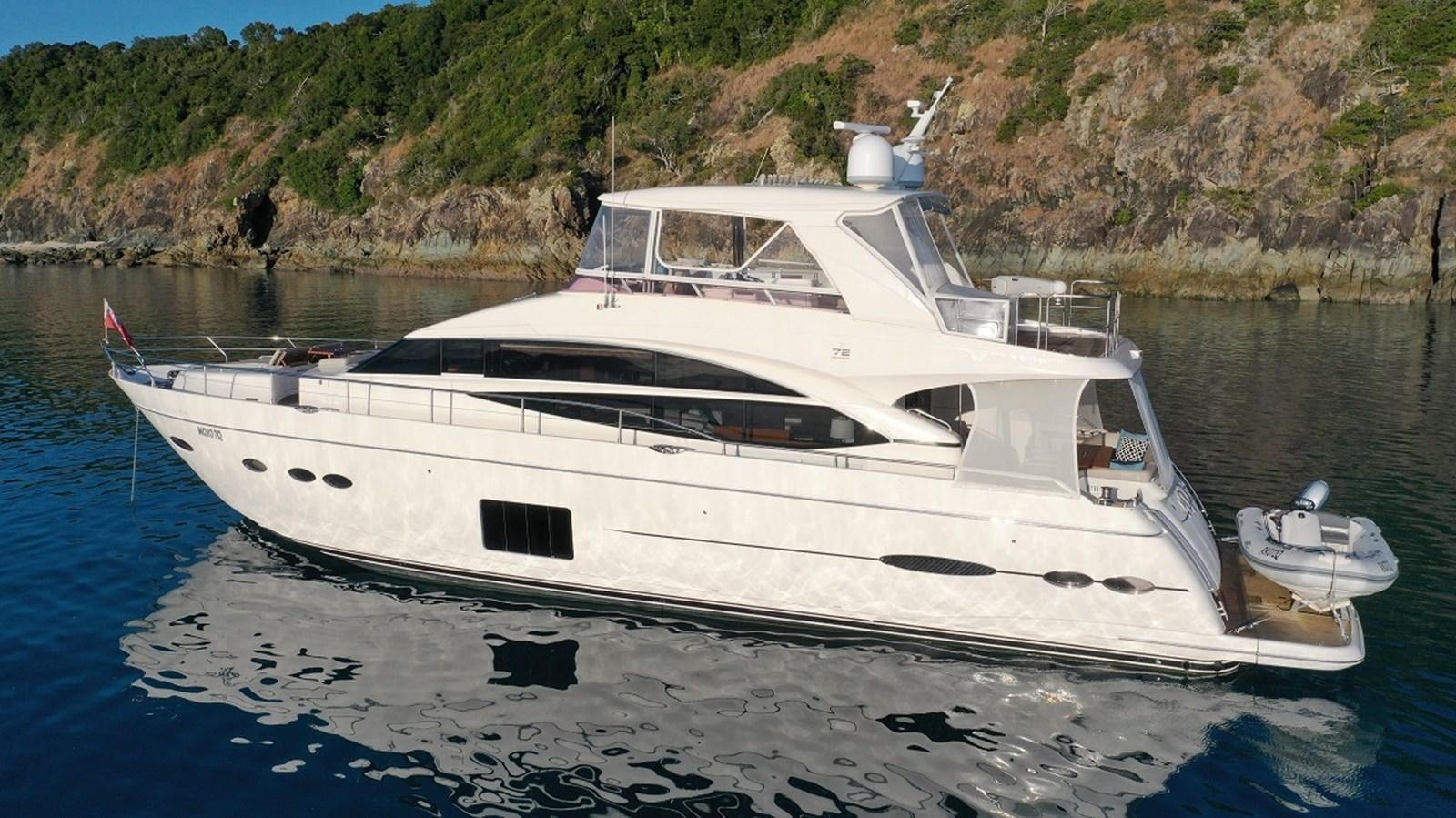 a white boat on the water aboard MOJO Yacht for Sale
