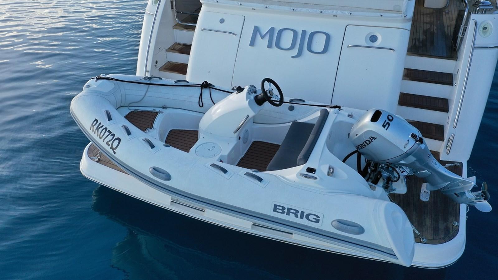 a white boat on the water aboard MOJO Yacht for Sale