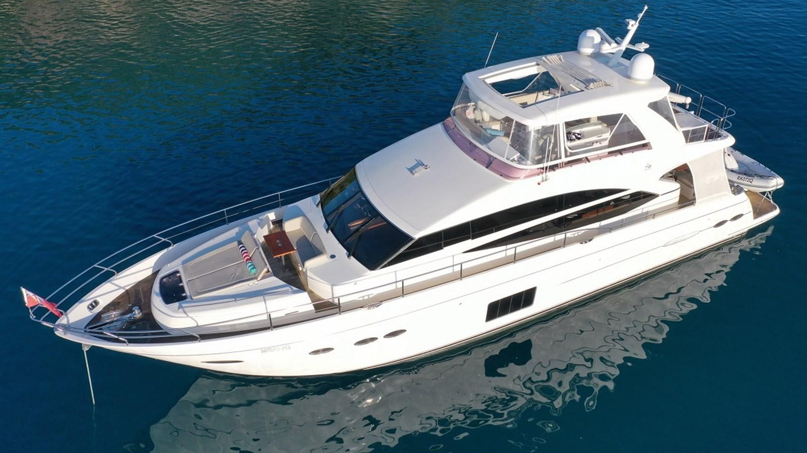 a white boat on the water aboard MOJO Yacht for Sale