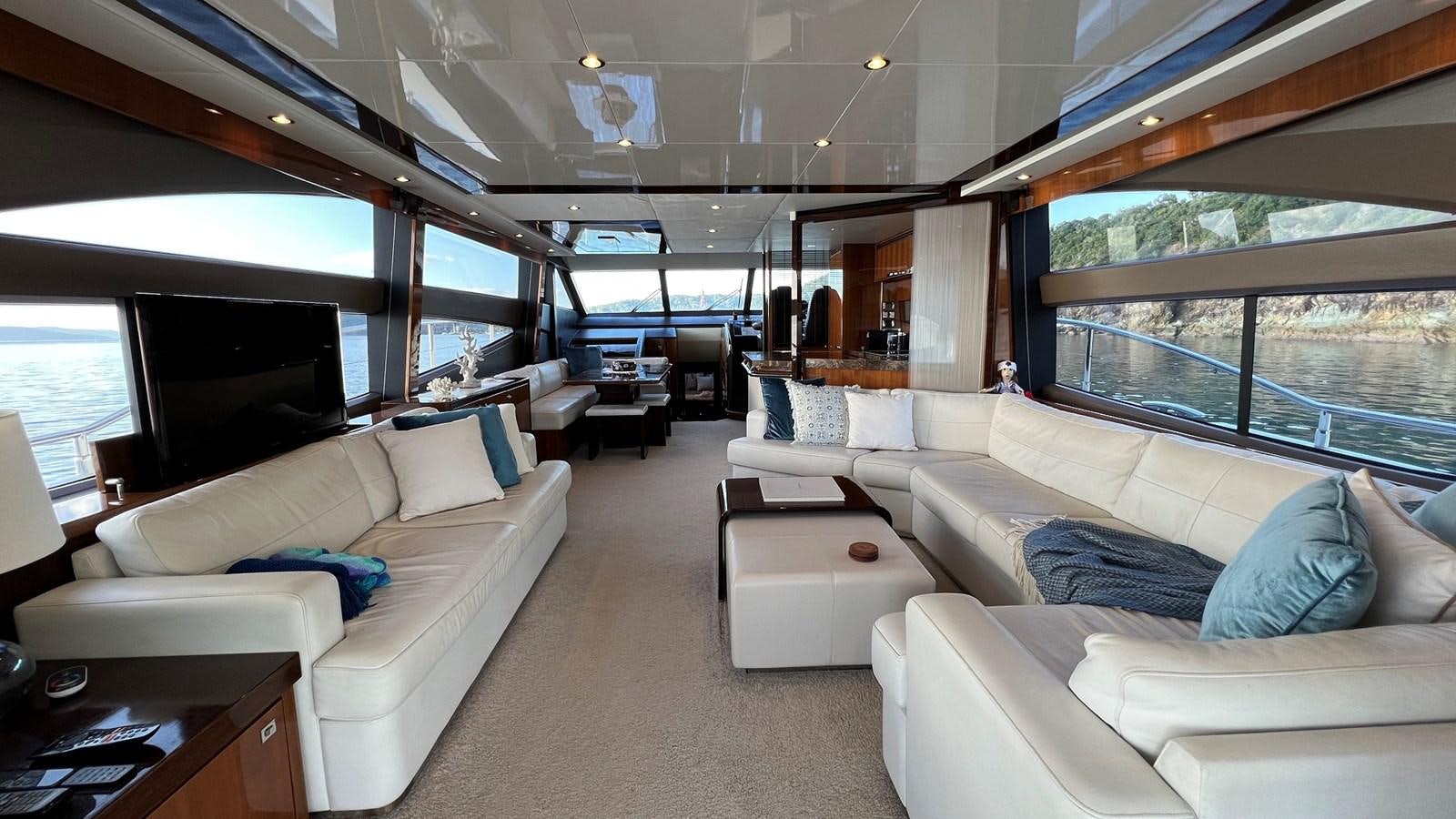 a living room with a large window aboard MOJO Yacht for Sale