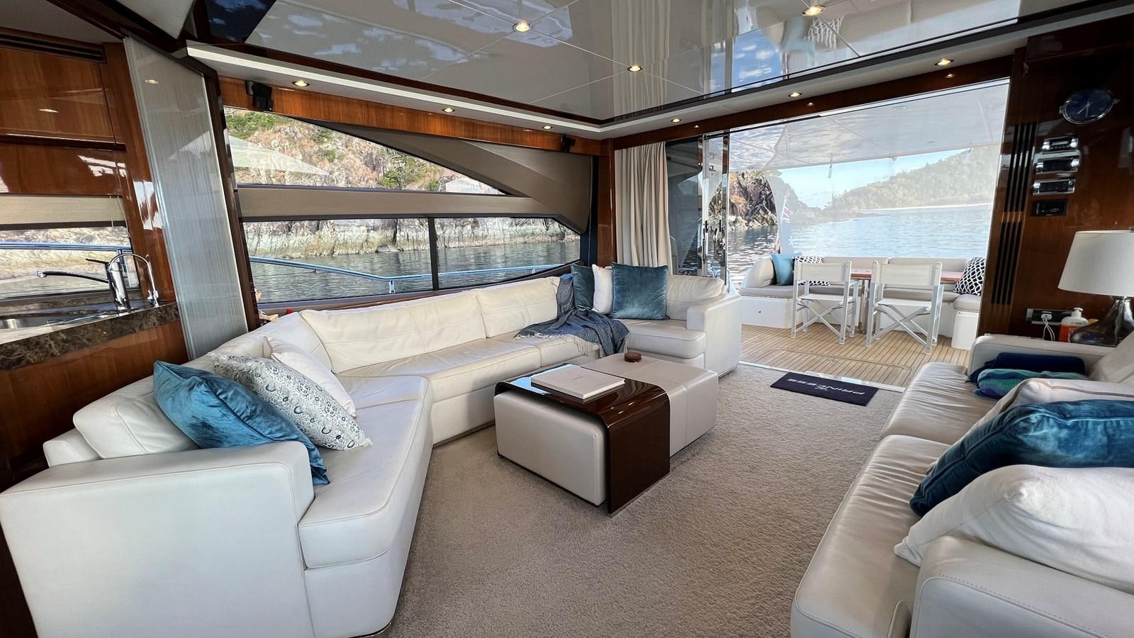a living room with a large window aboard MOJO Yacht for Sale