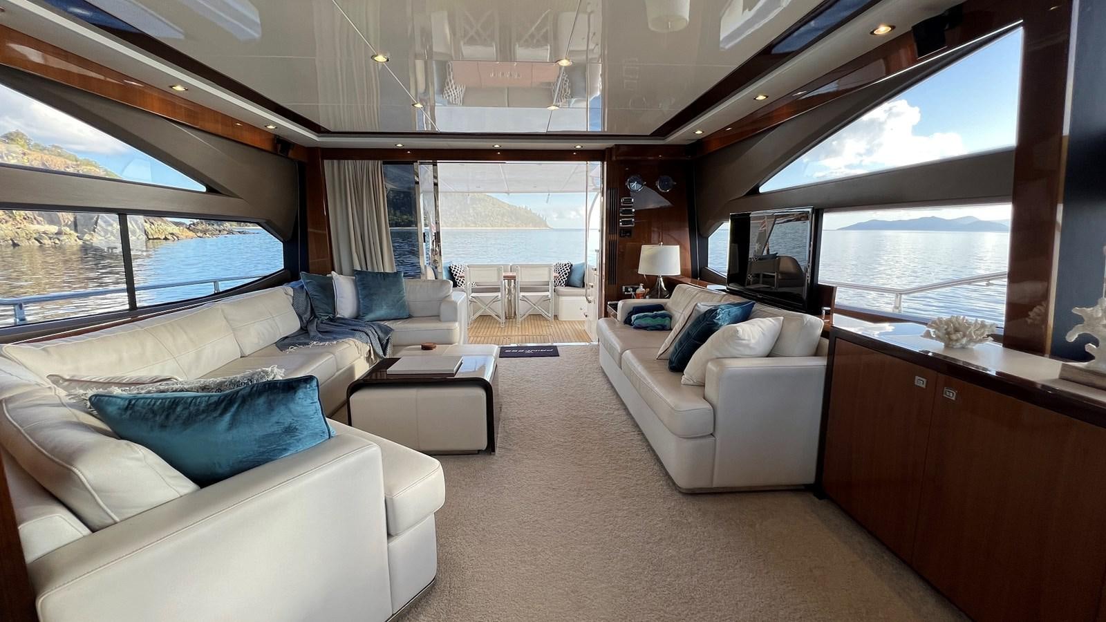 a living room with a large window aboard MOJO Yacht for Sale