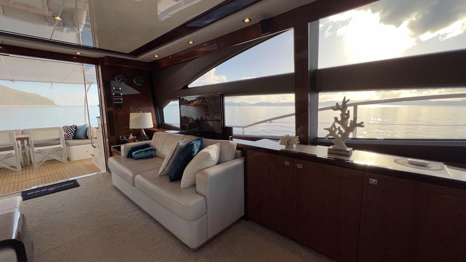 a living room with a large window aboard MOJO Yacht for Sale