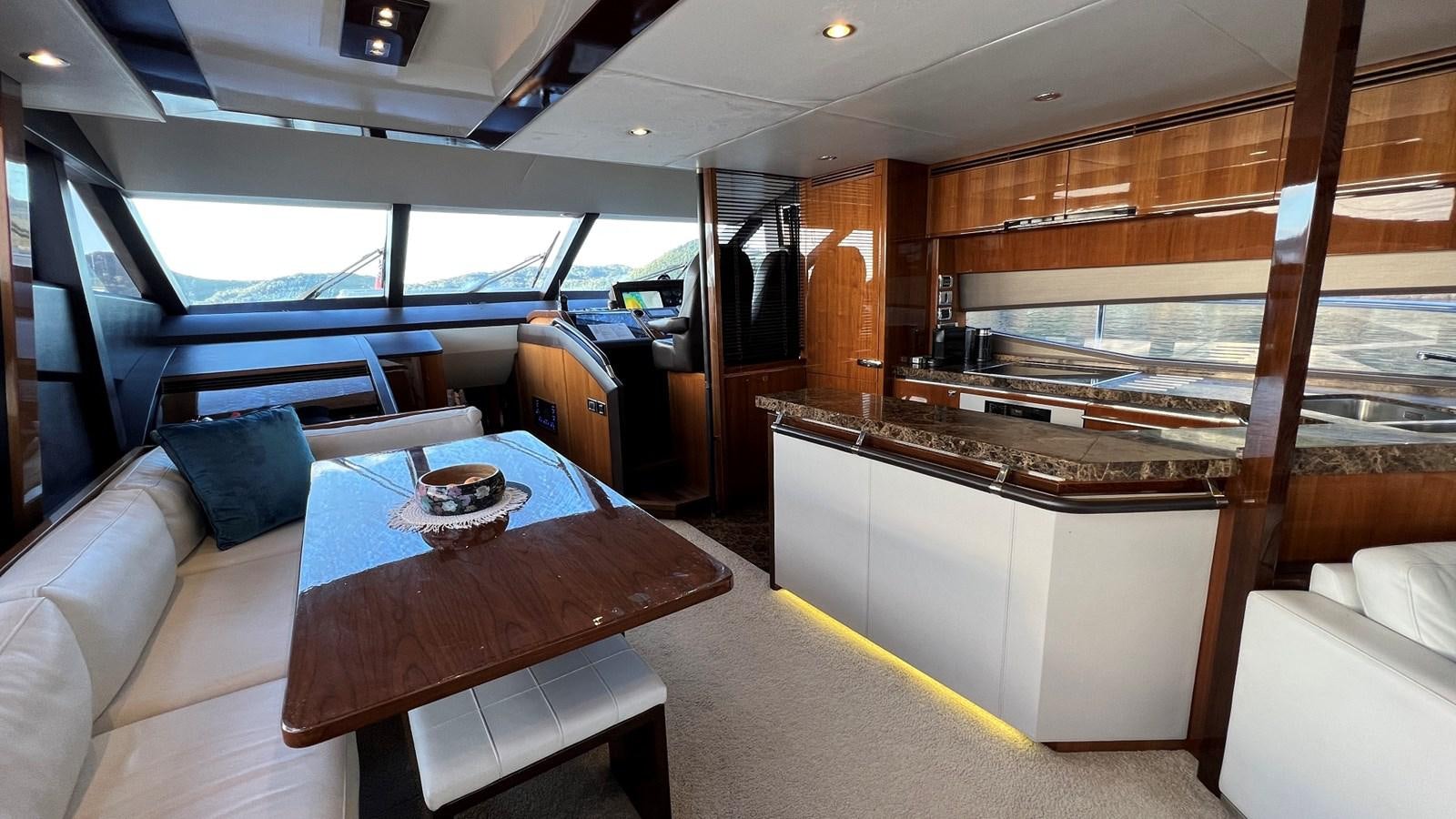 a room with a table and chairs aboard MOJO Yacht for Sale