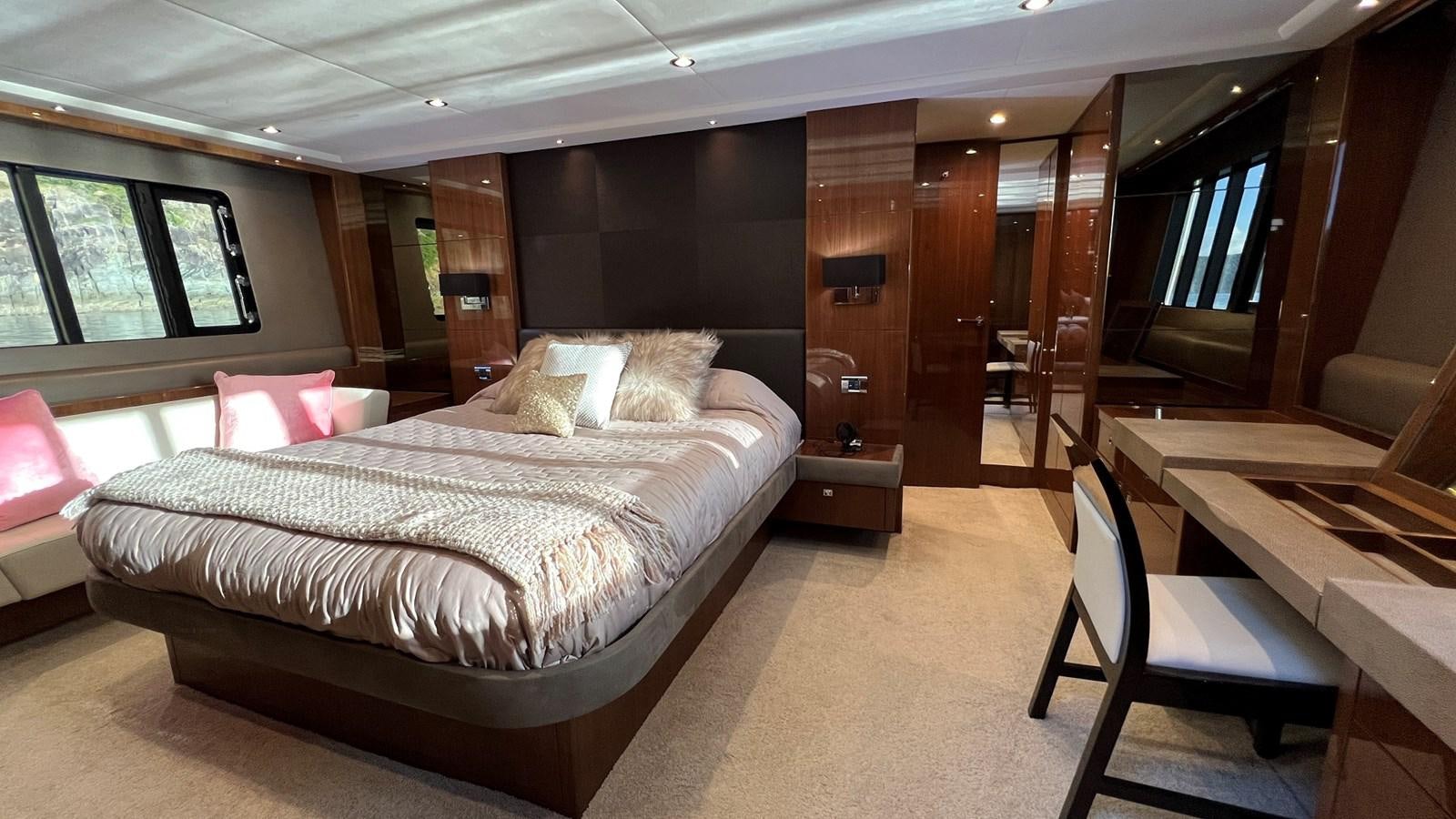 a room with a bed and a chair aboard MOJO Yacht for Sale
