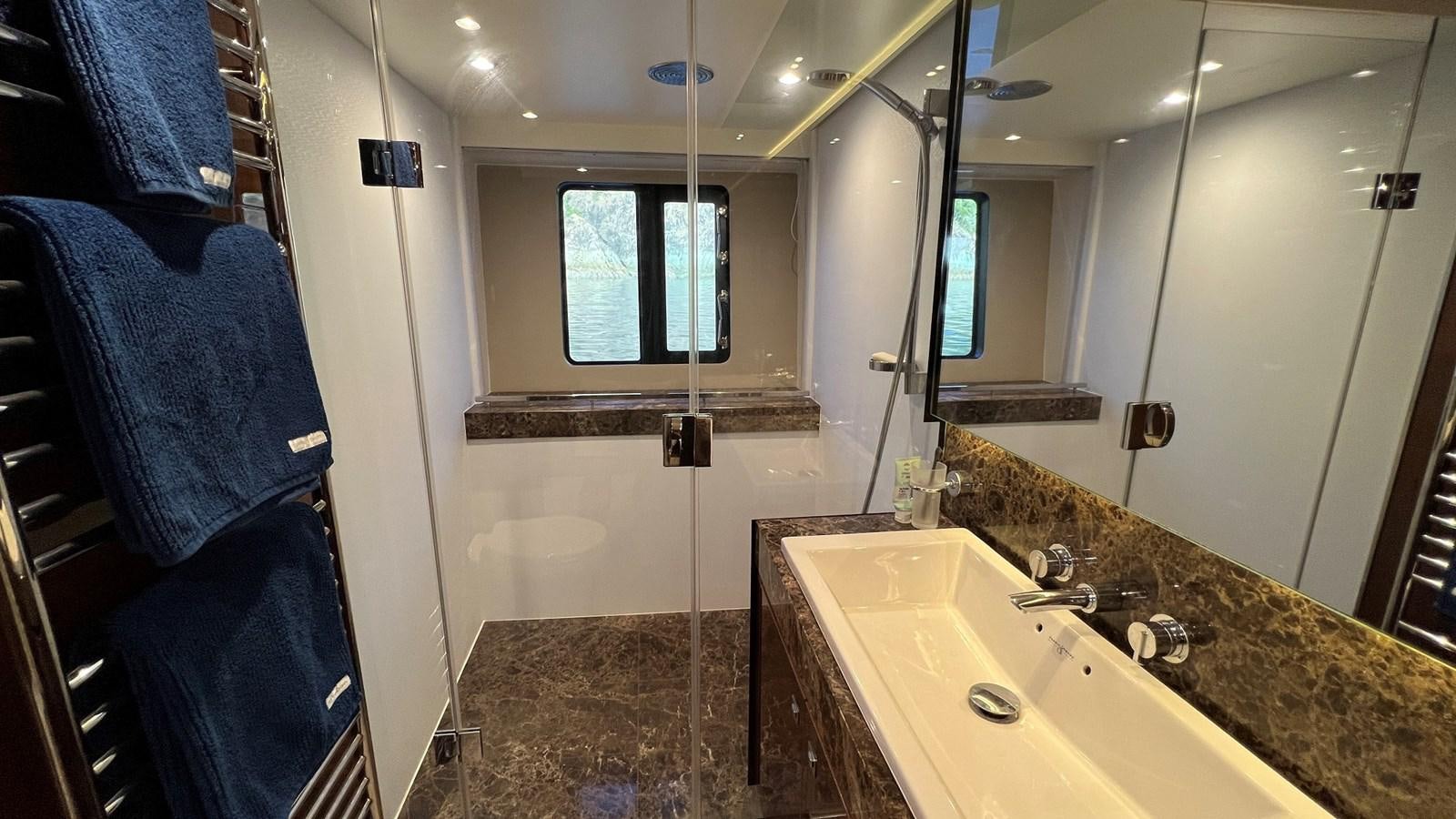 a bathroom with a marble counter top aboard MOJO Yacht for Sale