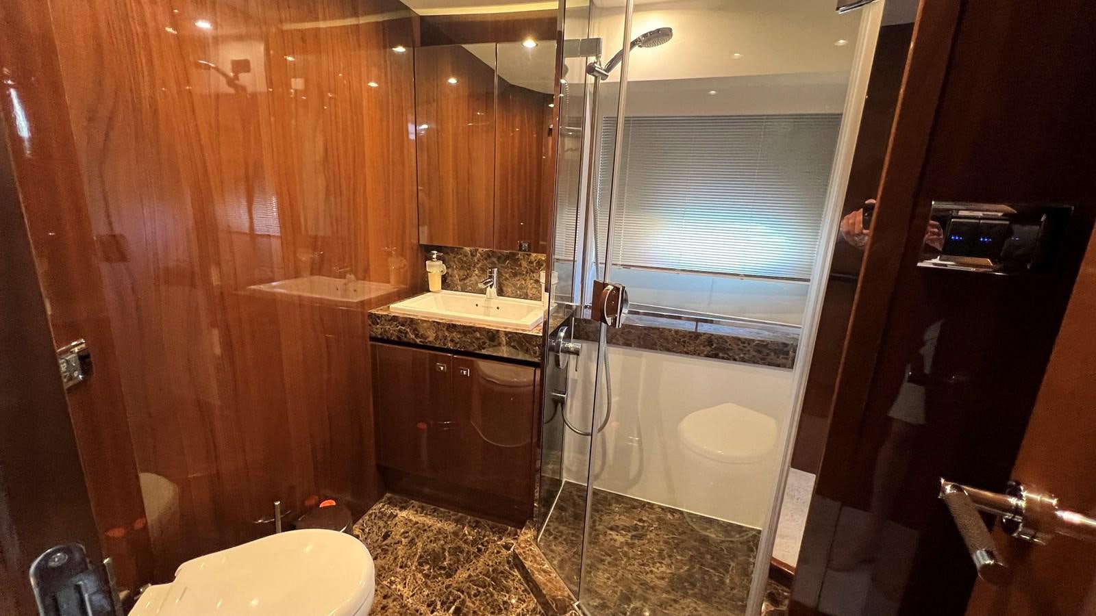 a bathroom with a shower and sink aboard MOJO Yacht for Sale