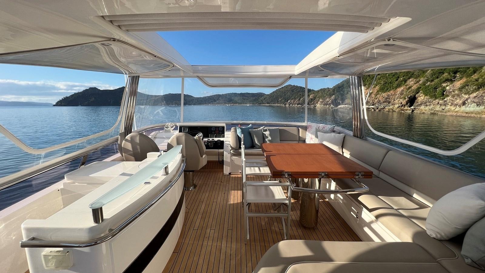 a boat with a table and chairs on it aboard MOJO Yacht for Sale