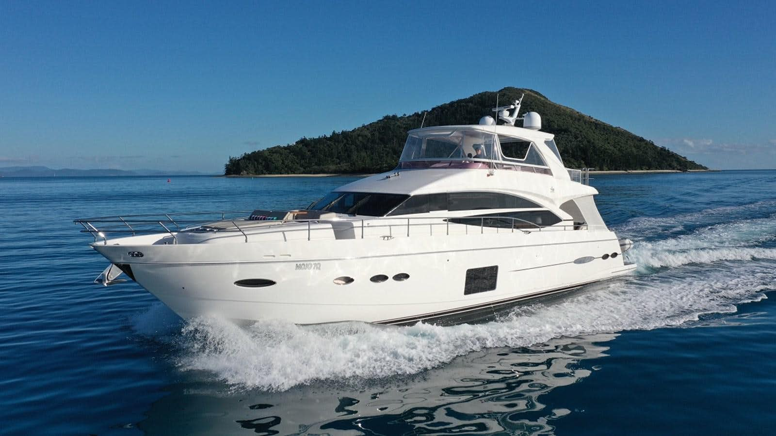 a white yacht on the water aboard MOJO Yacht for Sale