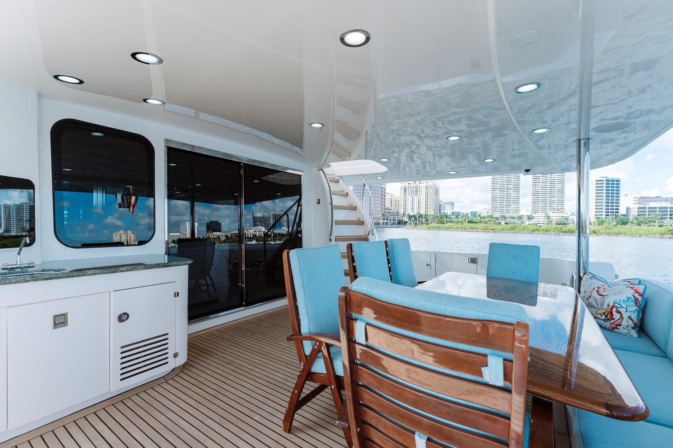 a boat with a table and chairs aboard FULLY OCCUPIED Yacht for Sale