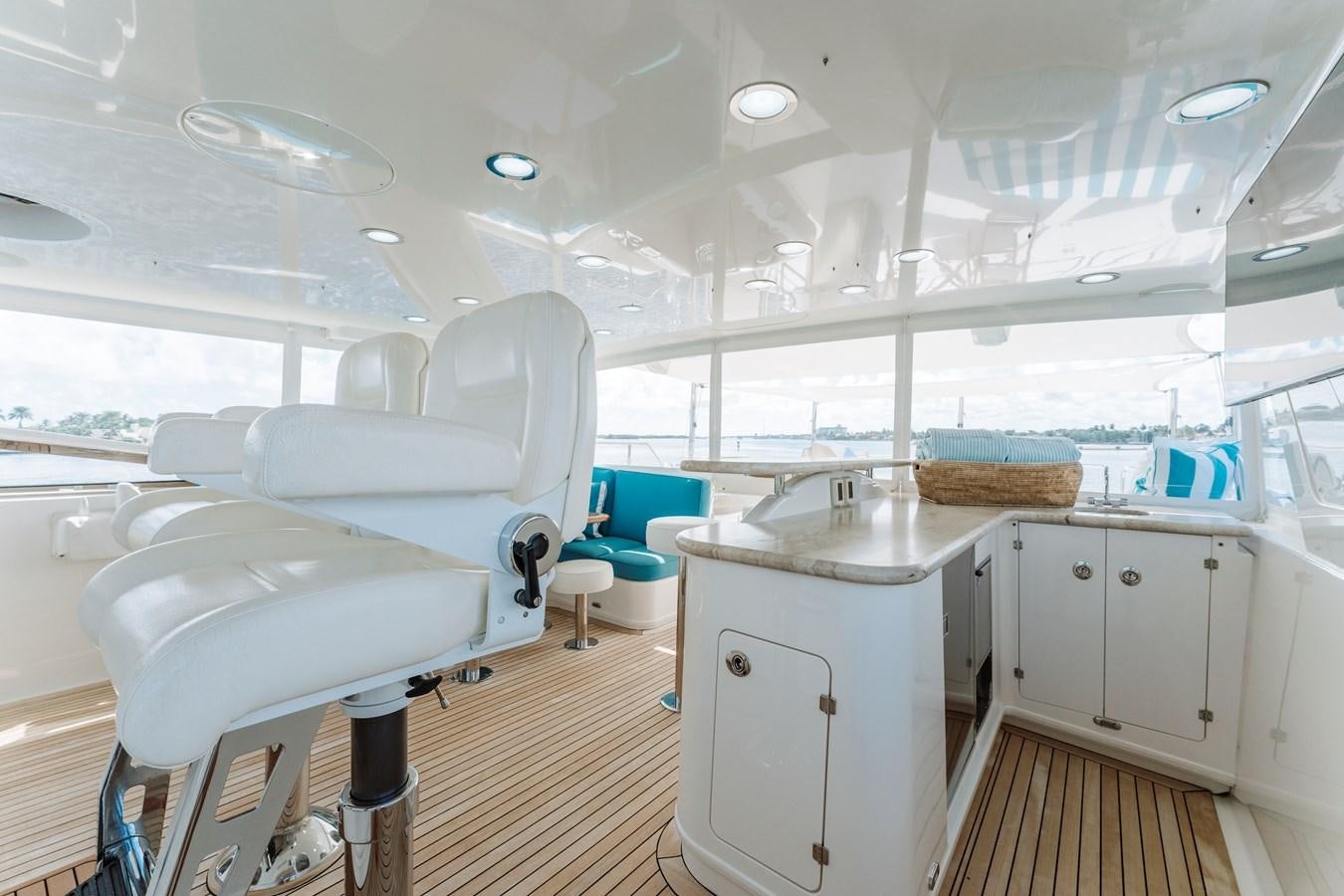 a room with a white chair and a desk and a large window aboard FULLY OCCUPIED Yacht for Sale