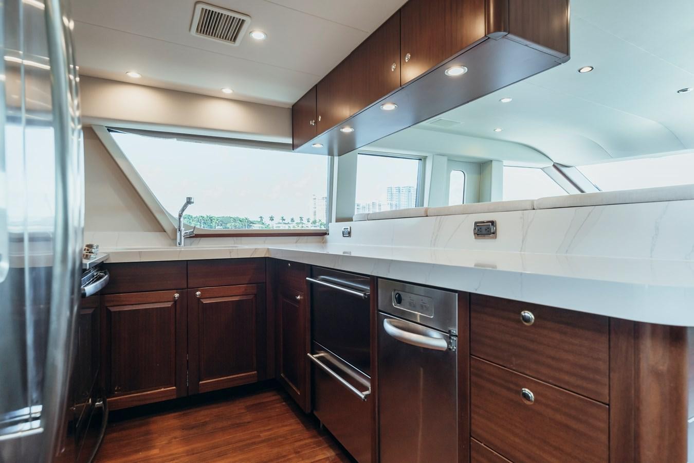 a kitchen with black cabinets aboard FULLY OCCUPIED Yacht for Sale