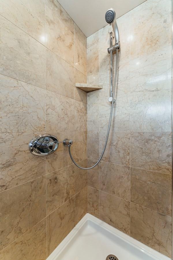 a shower with a shower head aboard FULLY OCCUPIED Yacht for Sale