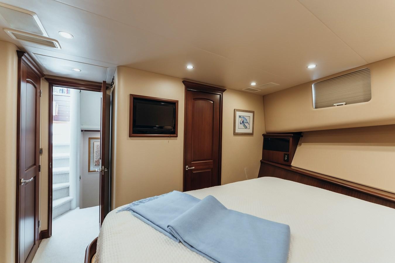 a hotel room with a bed and tv aboard FULLY OCCUPIED Yacht for Sale
