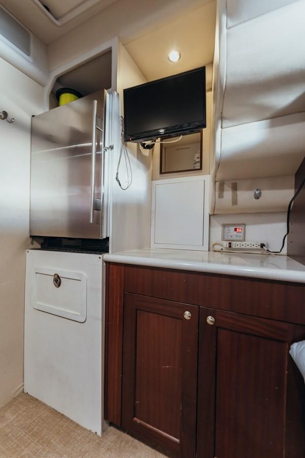 a kitchen with a microwave and a refrigerator aboard FULLY OCCUPIED Yacht for Sale