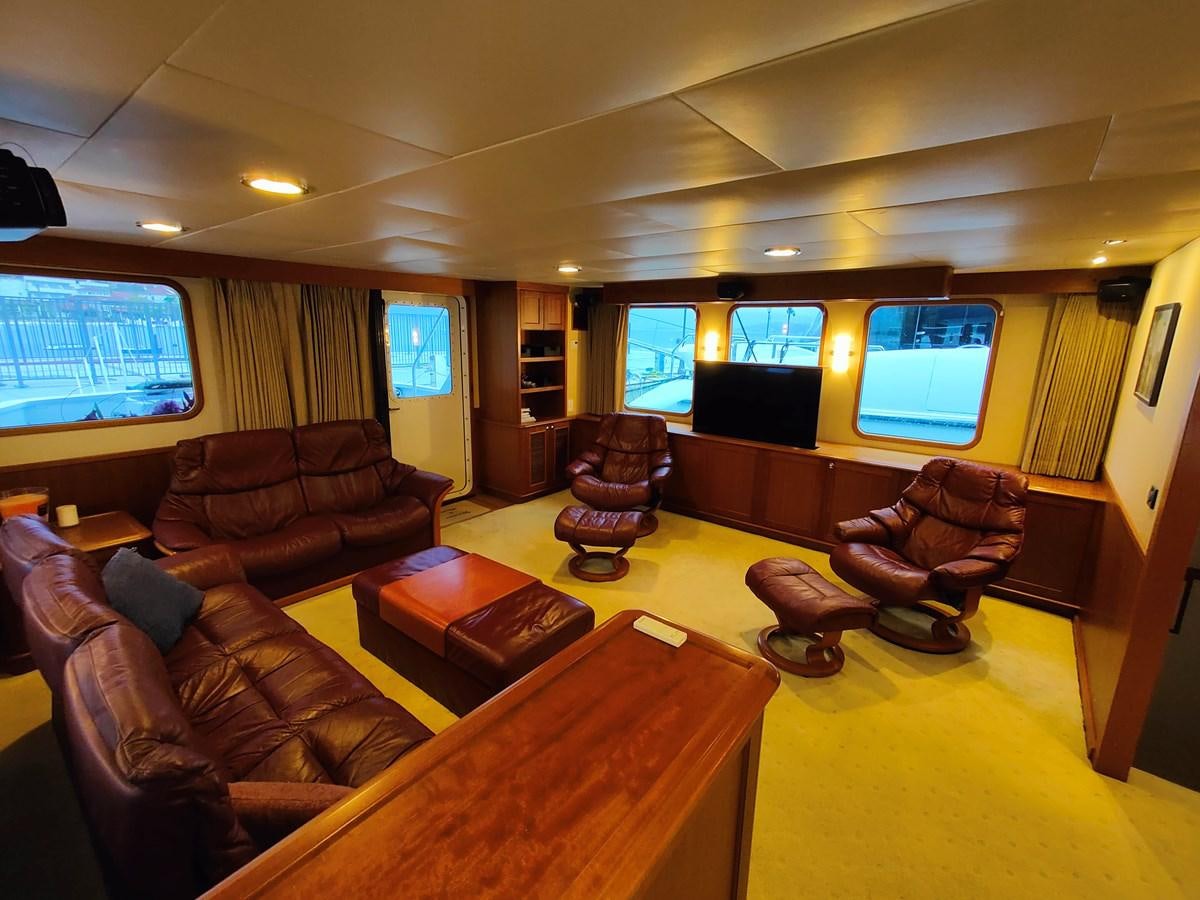 a living room with leather couches aboard SPELLBOUND Yacht for Sale