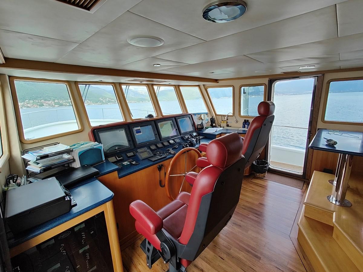 a room with a desk and chairs aboard SPELLBOUND Yacht for Sale