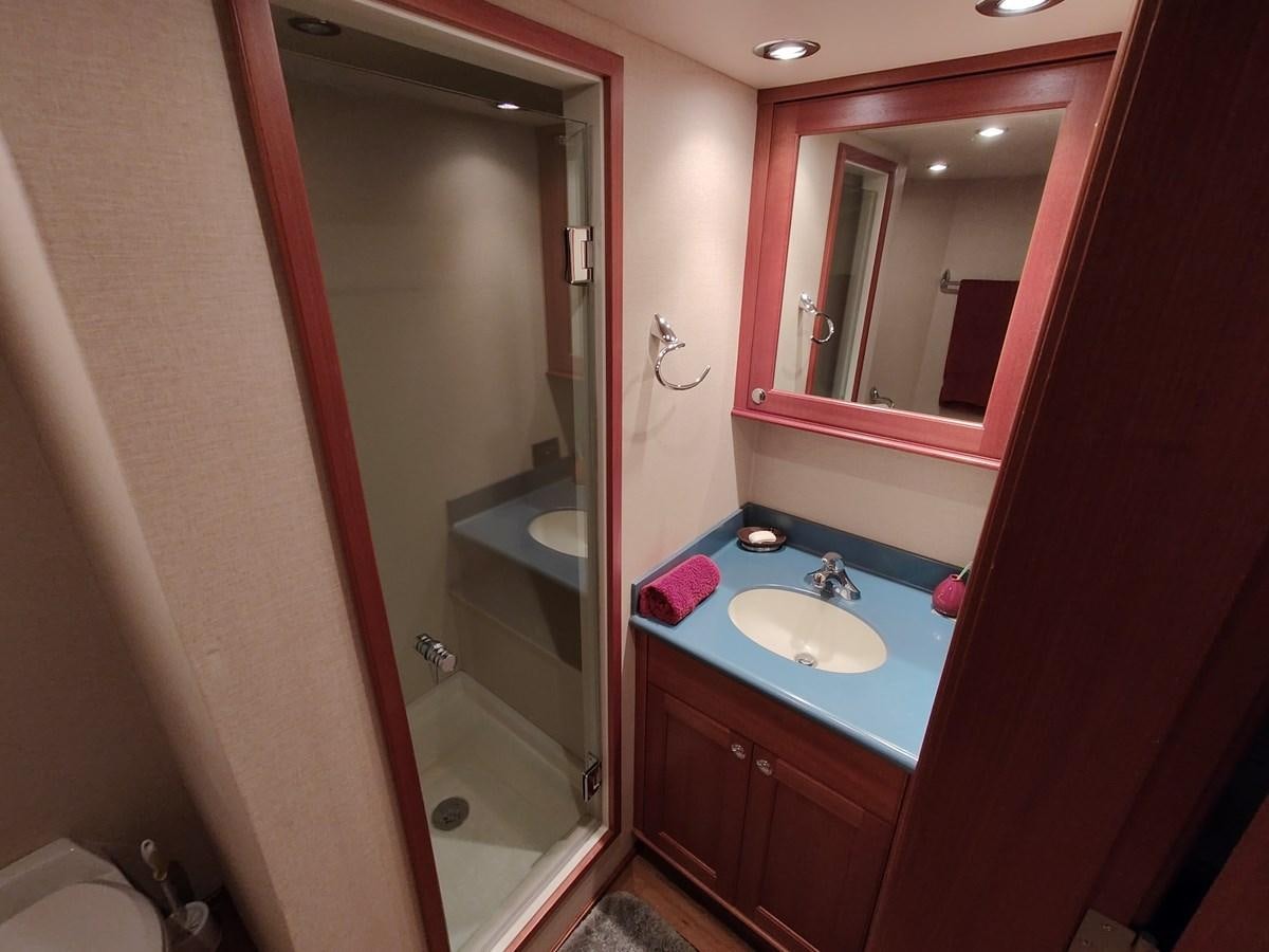 a bathroom with a sink and a shower aboard SPELLBOUND Yacht for Sale
