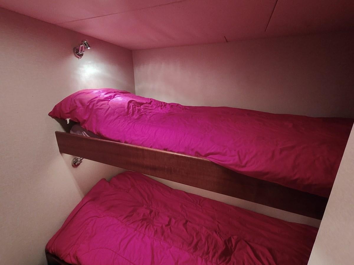 a bed with pink sheets aboard SPELLBOUND Yacht for Sale